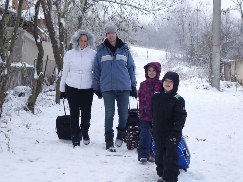 Family in the snow in Romania